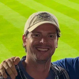 Tandi's founder, smiling at a baseball game